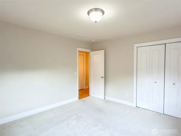 a view of an empty room and a window