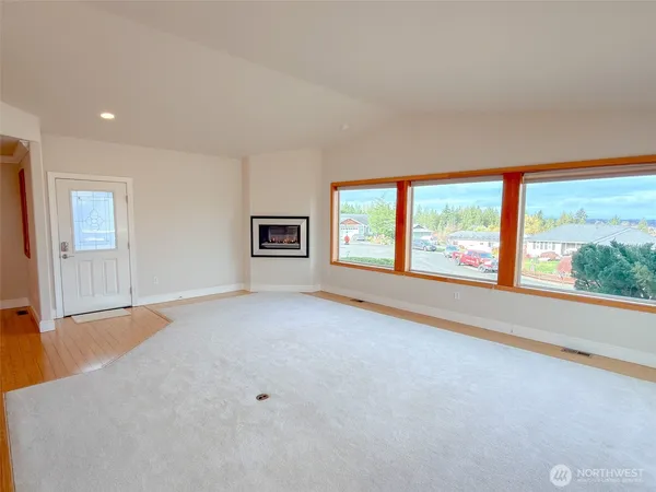 an empty room with windows and mountain view