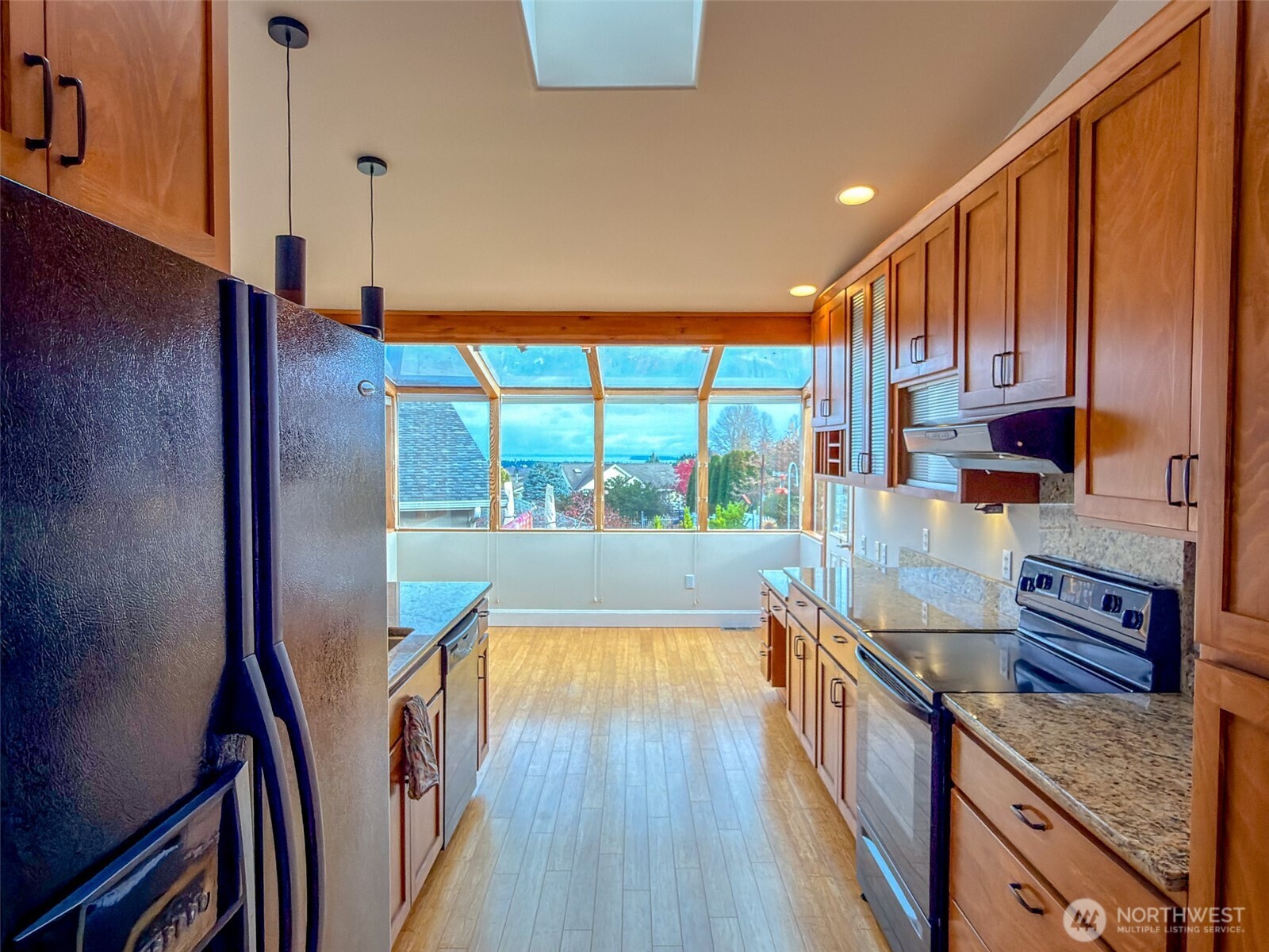 31 Opal Lane Sequim, WA 98382 - Photo 10 of 40 a kitchen with stainless steel appliances granite countertop a refrigerator a stove and a wooden floors