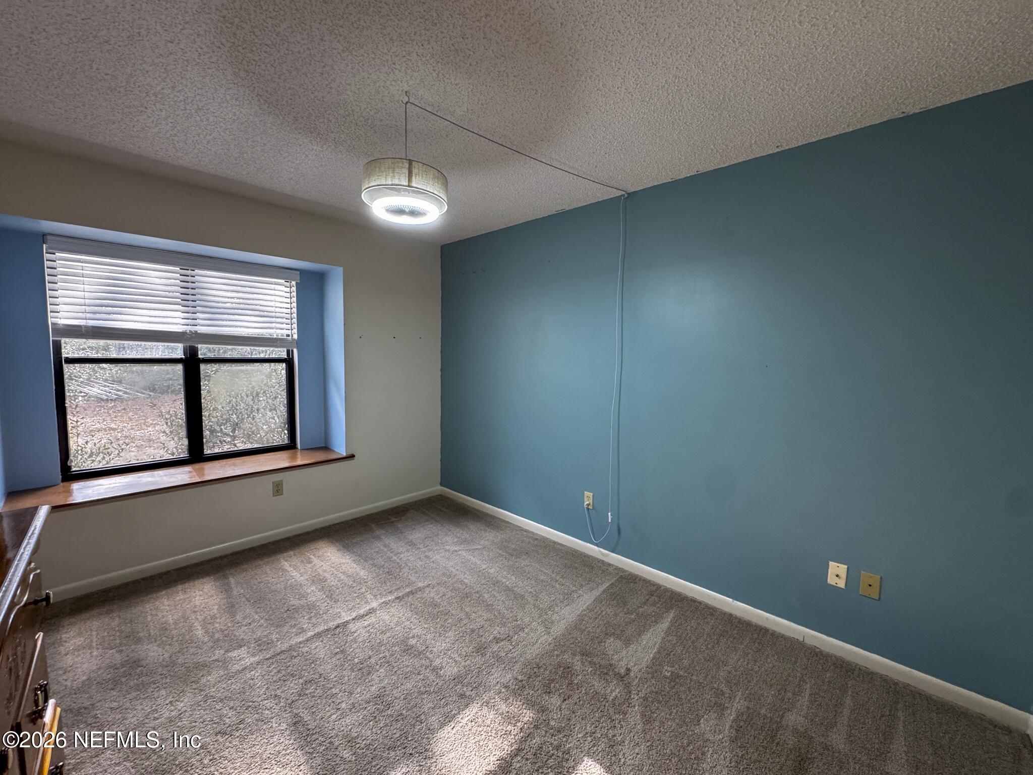 114 Mandarin Lake Road Melrose, FL 32666 - Photo 11 of 26 an empty room with windows and closet