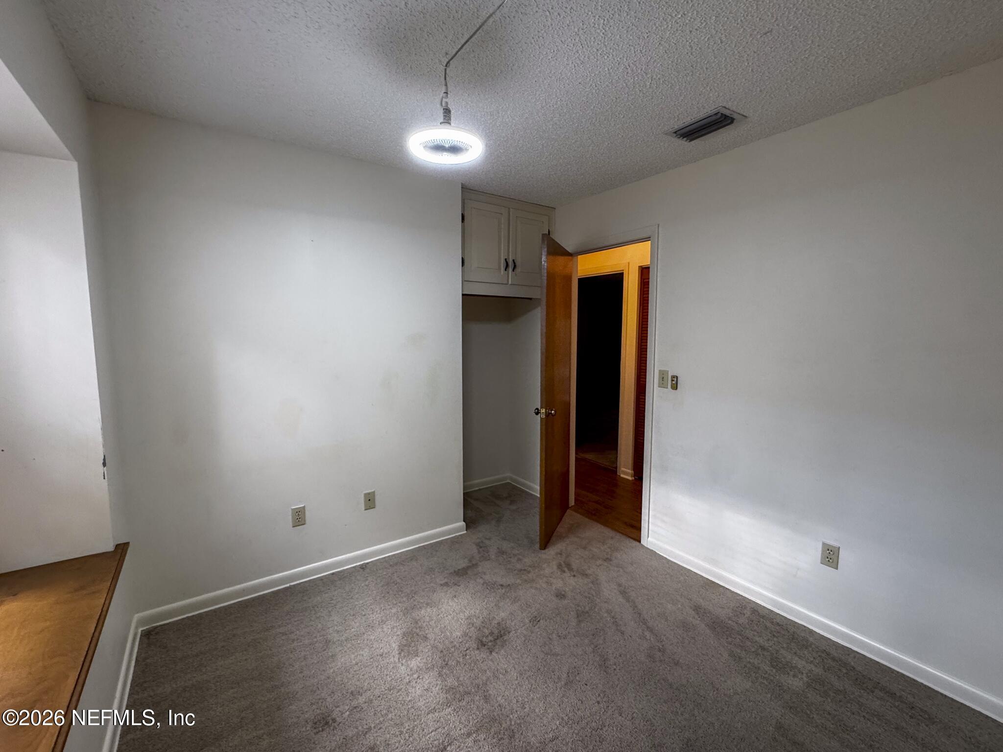 114 Mandarin Lake Road Melrose, FL 32666 - Photo 13 of 26 an empty room with closet and wooden floor