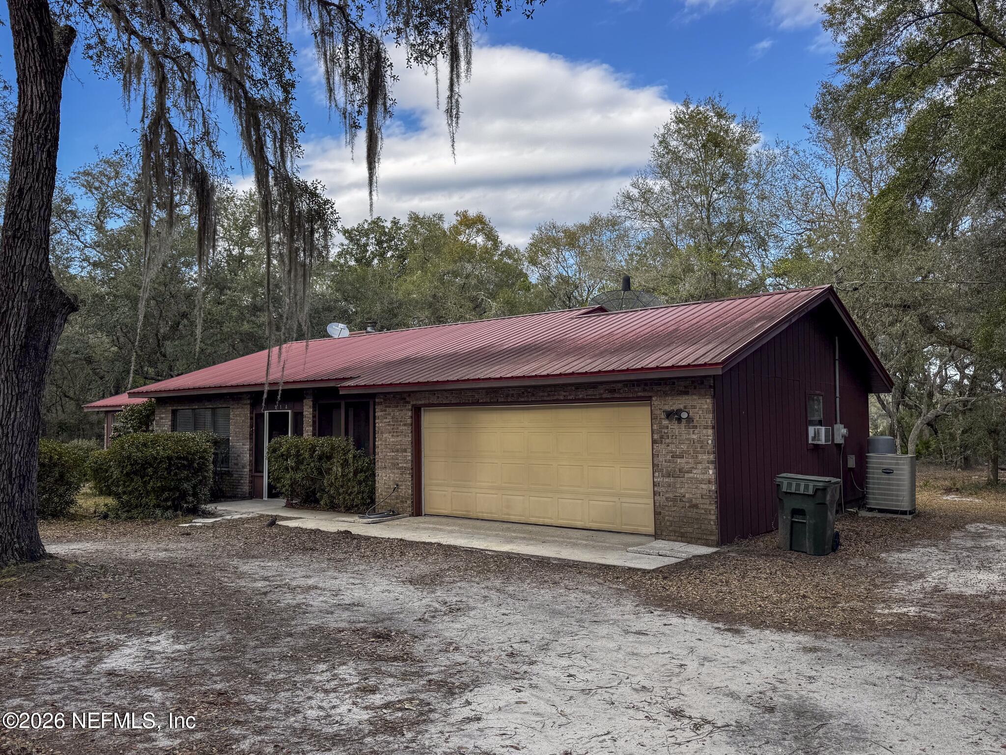 114 Mandarin Lake Road Melrose, FL 32666 - Photo 2 of 26 a view of a house with a yard and garage