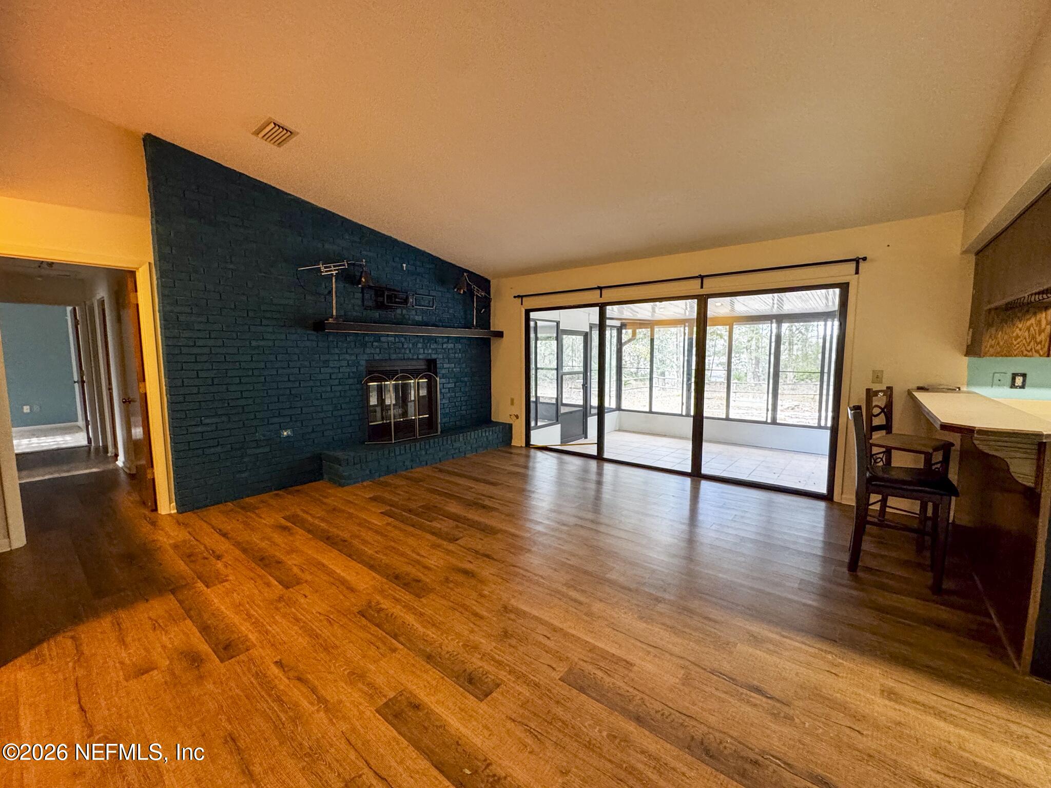 114 Mandarin Lake Road Melrose, FL 32666 - Photo 4 of 26 a furnished livingroom with windows and wooden floor