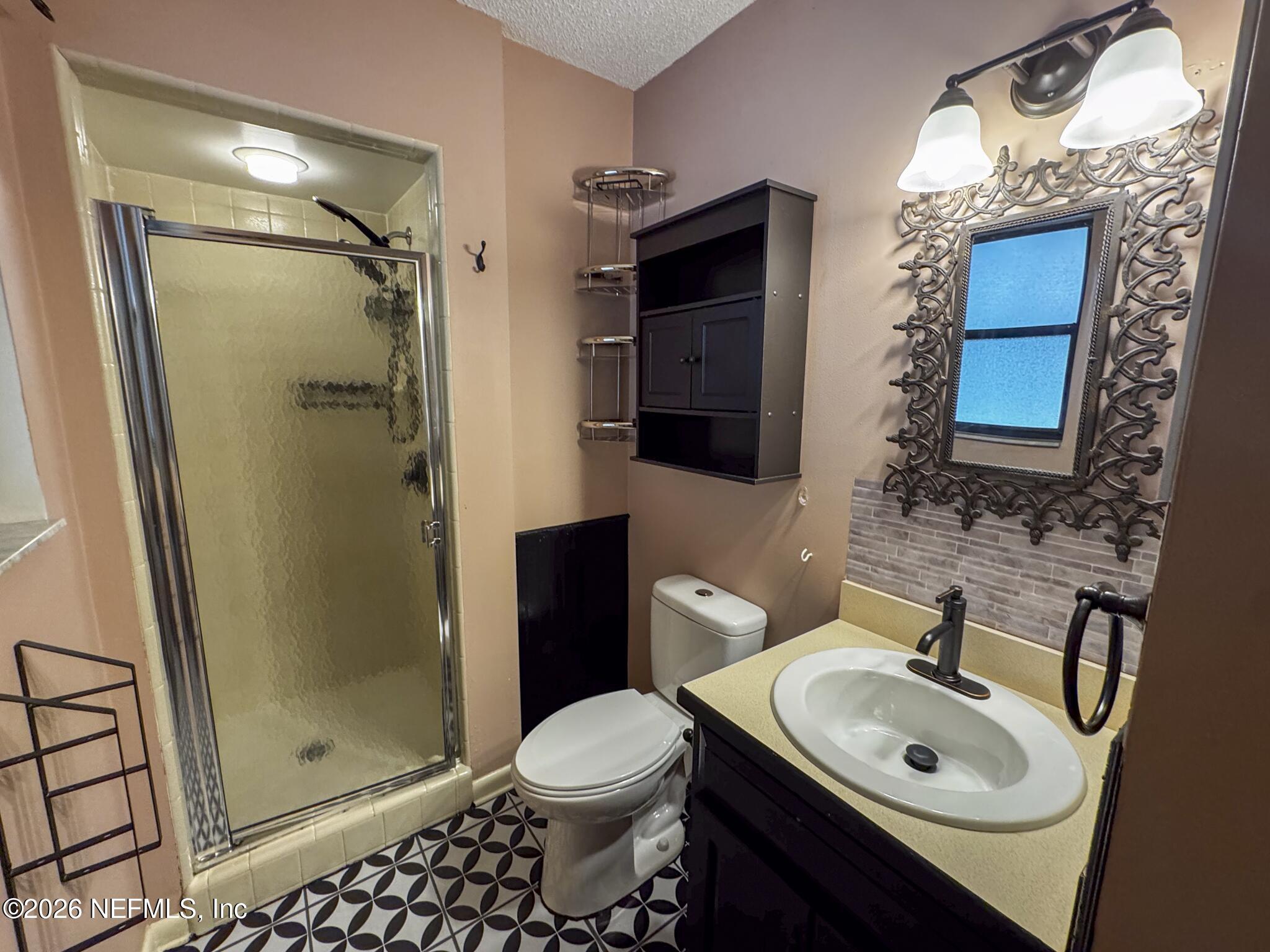 114 Mandarin Lake Road Melrose, FL 32666 - Photo 7 of 26 a bathroom with a sink toilet and shower