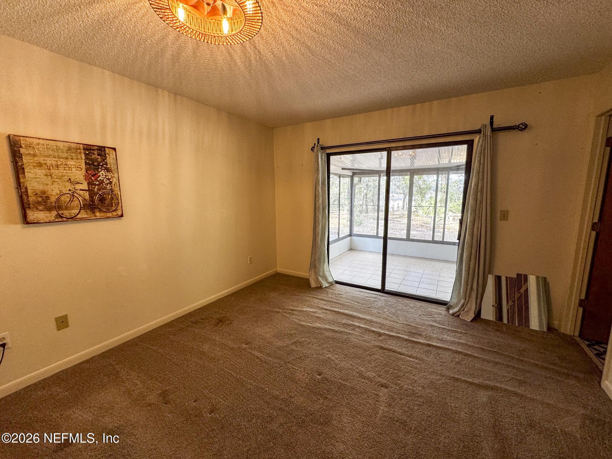 114 Mandarin Lake Road Melrose, FL 32666 - Photo 9 of 26 a view of an empty room with a window