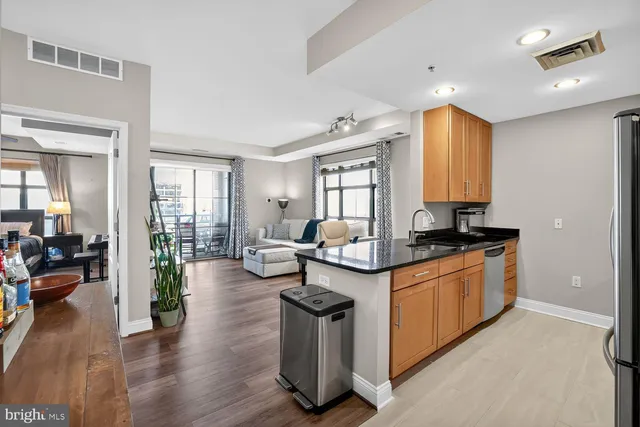 a kitchen with sink and living room