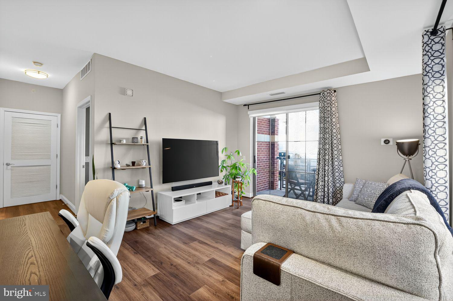 1111 Oronoco Street, Unit 125 Alexandria, VA 22314 - Photo 6 of 20 a living room with furniture and a flat screen tv