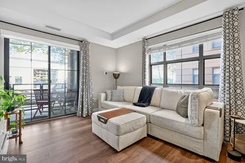 a living room with furniture and a large window with outer view