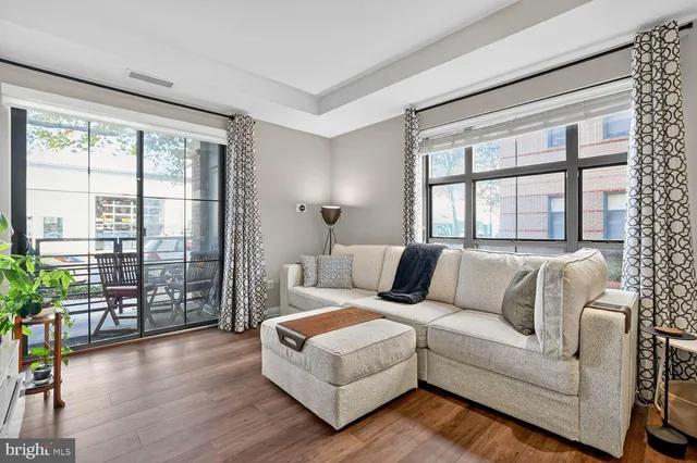 a living room with furniture and a large window with outer view