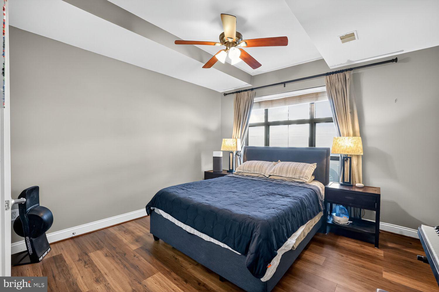 1111 Oronoco Street, Unit 125 Alexandria, VA 22314 - Photo 9 of 20 a bedroom with a bed and a chandelier