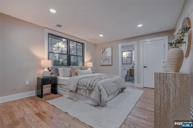 a spacious bedroom with a large bed and a window