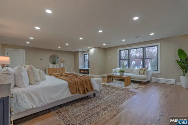 a bathroom with a tub a sink shower and mirror
