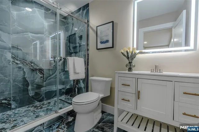 a backyard of a house with plants and large tree