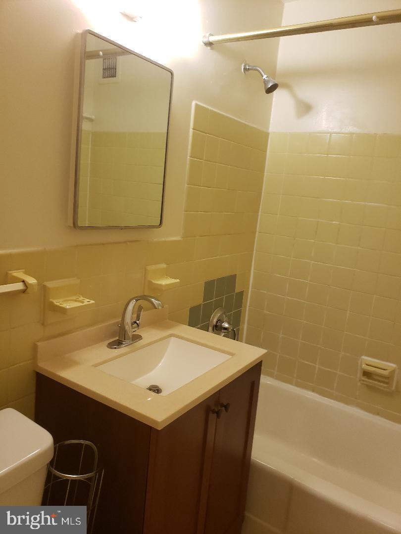 1111 Arlington Boulevard, Unit 815 Arlington, VA 22209 - Photo 14 of 32 a bathroom with a sink and a mirror