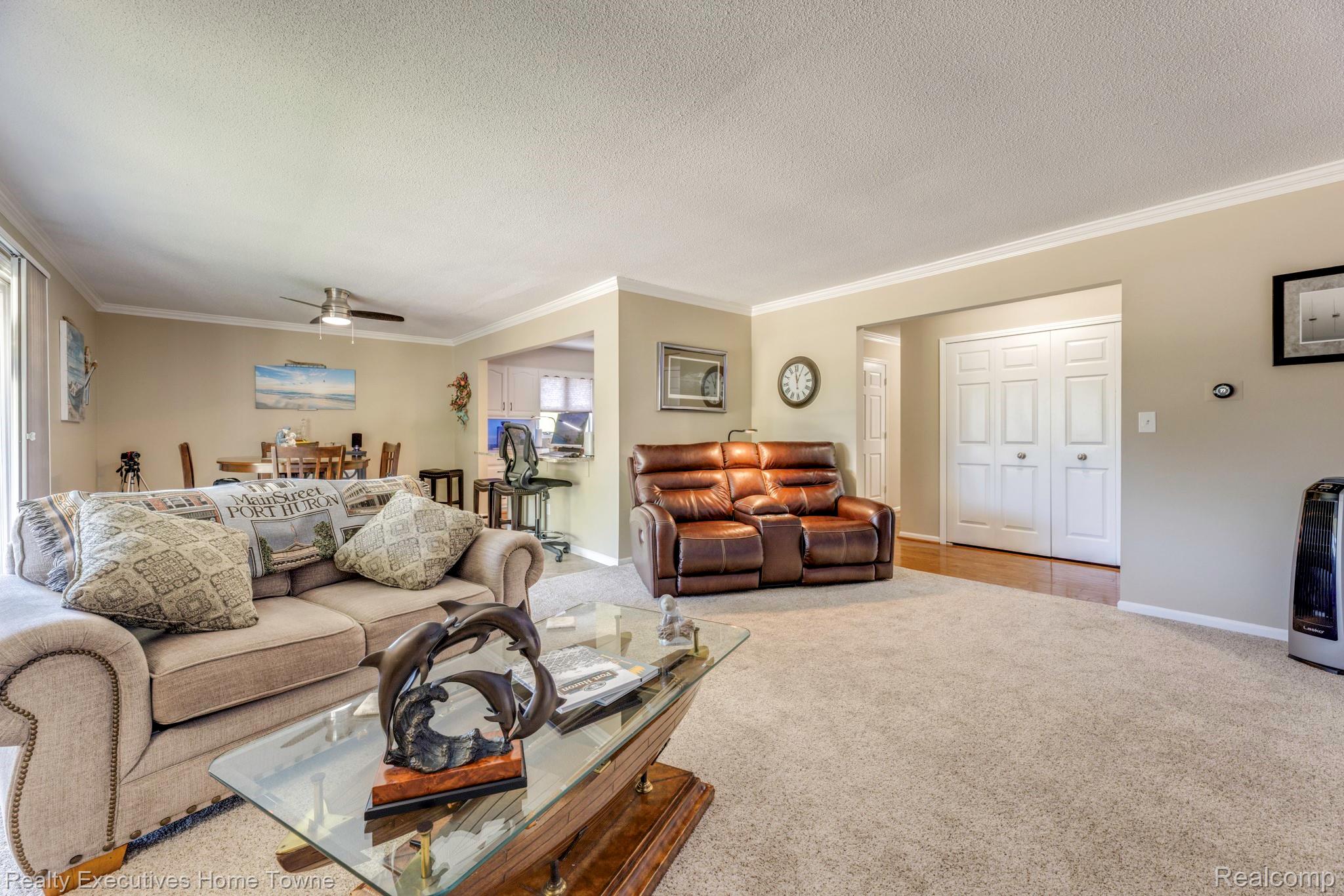 1467 Krafft Road, Unit 8 Port Huron, MI 48060 - Photo 8 of 30 Expansive living area with neutral carpeting, crown molding, and light gray wall paint