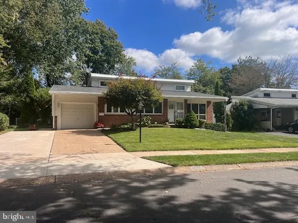 a view of a house with a backyard and a garage