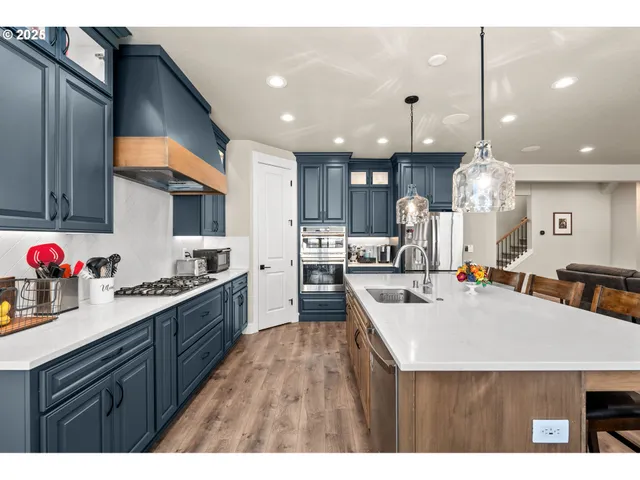 a kitchen with a table chairs sink and cabinets