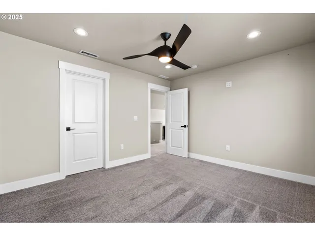 a bathroom with a sink a toilet a mirror and shower