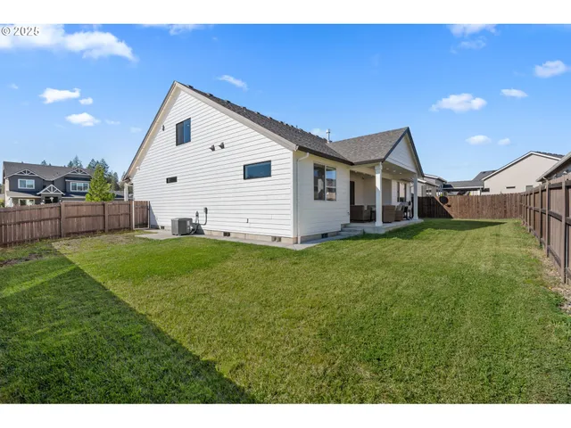 a view of a house with a yard and sitting area