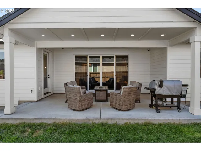 a living room with furniture and a floor to ceiling window