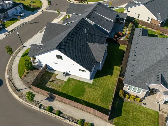 an aerial view of a house with a swimming pool