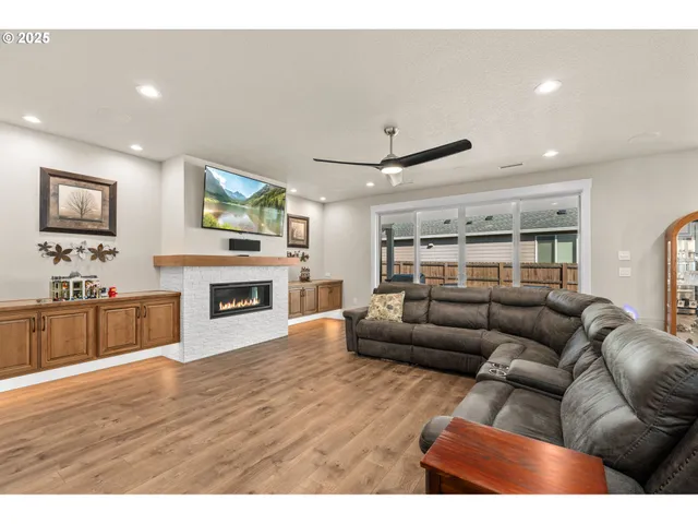 a living room with furniture a fireplace and a flat screen tv