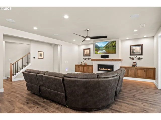 a living room with lots of furniture a fireplace and kitchen view