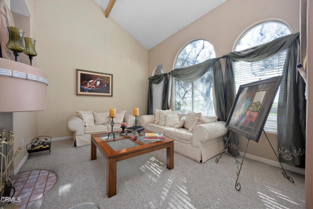 5705 Valley Street Bakersfield, CA 93306 - Photo 16 of 53 a living room with furniture a large window and a chandelier