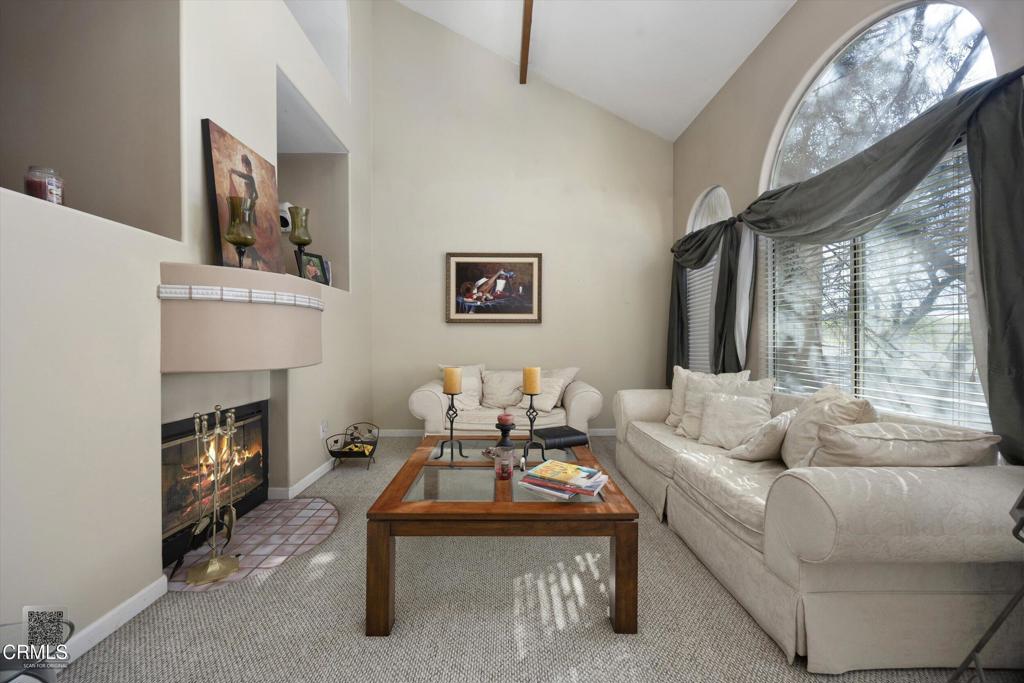 5705 Valley Street Bakersfield, CA 93306 - Photo 18 of 53 a living room with furniture a fireplace and a large mirror