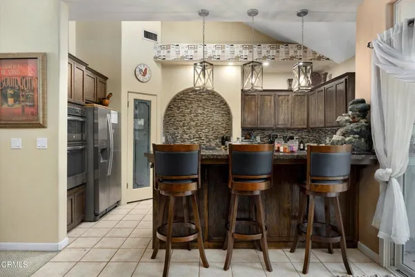 a kitchen with stainless steel appliances a sink stove and cabinets
