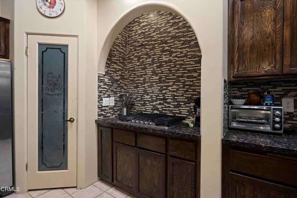 5705 Valley Street Bakersfield, CA 93306 - Photo 28 of 53 a kitchen with a refrigerator and a stove top oven