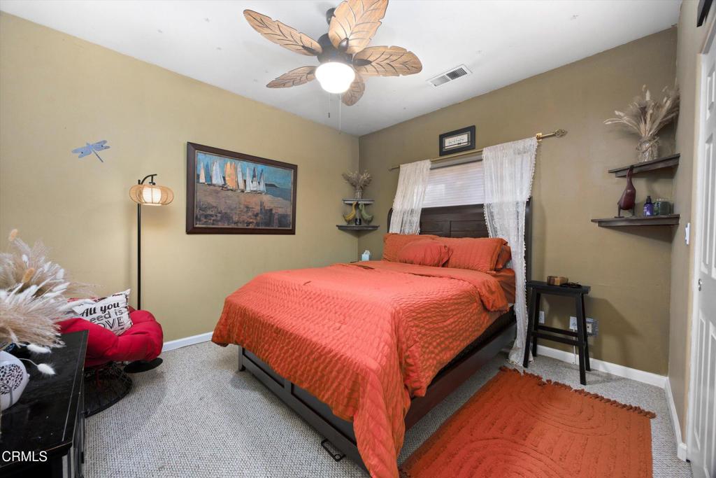 5705 Valley Street Bakersfield, CA 93306 - Photo 36 of 53 a bedroom with a bed and a chandelier