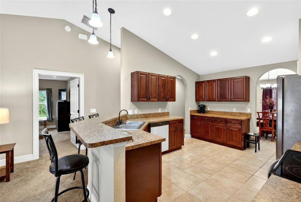 3001 Southwest 173rd Street Road Ocala, FL 34473 - Photo 13 of 28 a kitchen with stainless steel appliances granite countertop a sink and a refrigerator