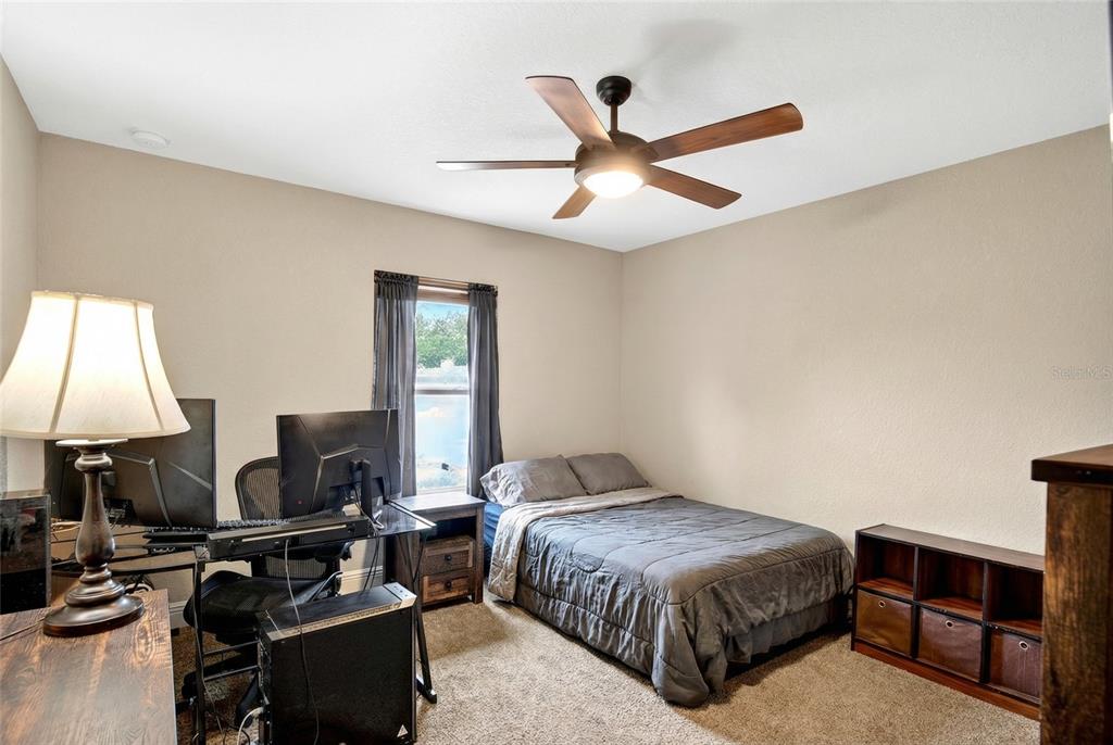 3001 Southwest 173rd Street Road Ocala, FL 34473 - Photo 19 of 28 a bedroom with a bed and a chandelier