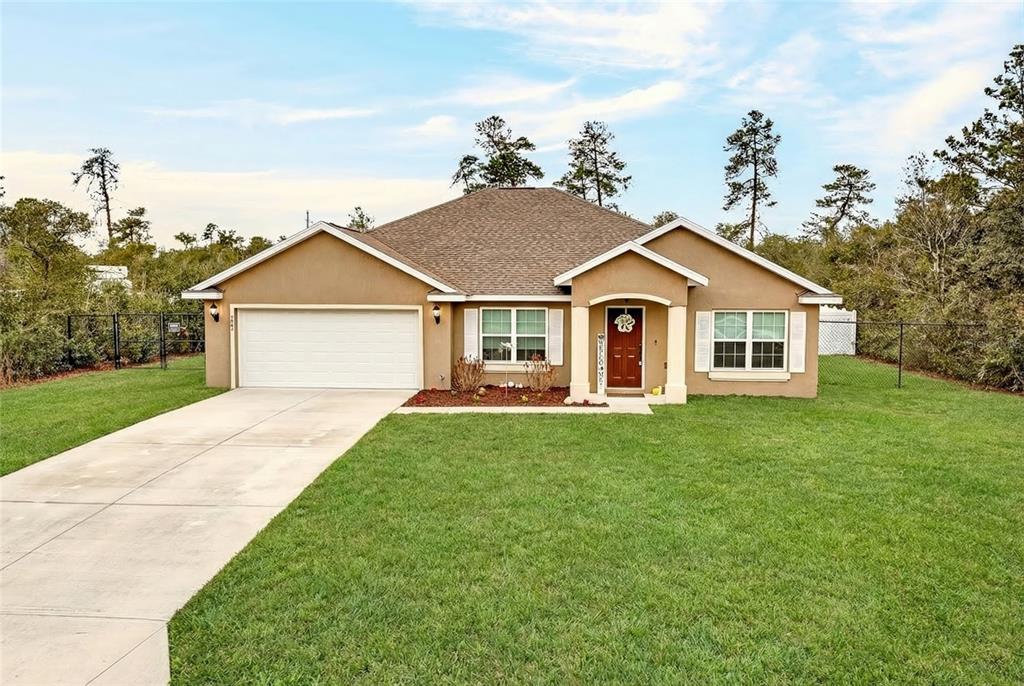 3001 Southwest 173rd Street Road Ocala, FL 34473 - Photo 2 of 28 a view of a yard in front of a house with plants and large tree