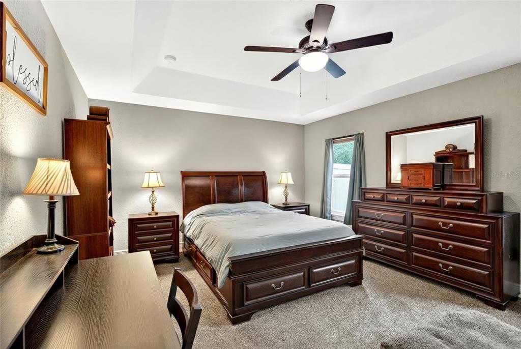 3001 Southwest 173rd Street Road Ocala, FL 34473 - Photo 22 of 28 a bedroom with a bed and a chandelier