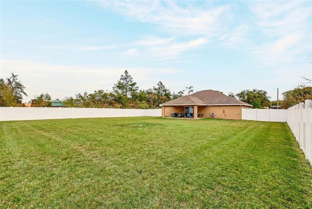 3001 Southwest 173rd Street Road Ocala, FL 34473 - Photo 27 of 28 a view of a house with a yard and a large tree center in it