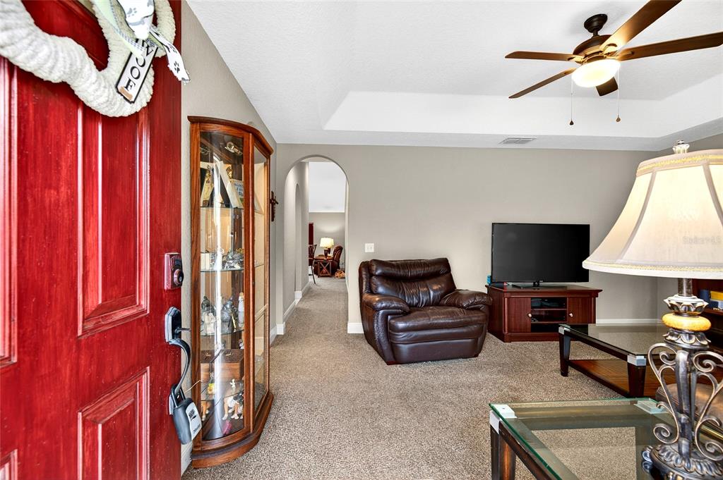 3001 Southwest 173rd Street Road Ocala, FL 34473 - Photo 3 of 28 a living room with furniture a flat screen tv and a window