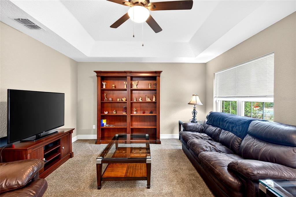 3001 Southwest 173rd Street Road Ocala, FL 34473 - Photo 4 of 28 a living room with furniture and a flat screen tv
