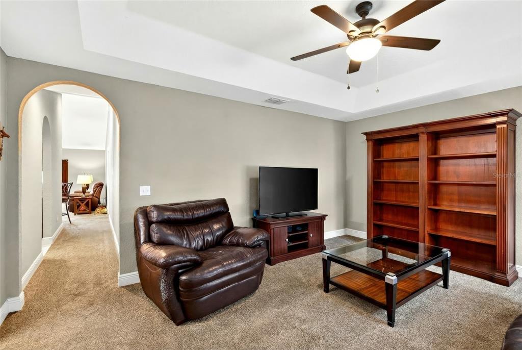 3001 Southwest 173rd Street Road Ocala, FL 34473 - Photo 5 of 28 a living room with furniture and a flat screen tv