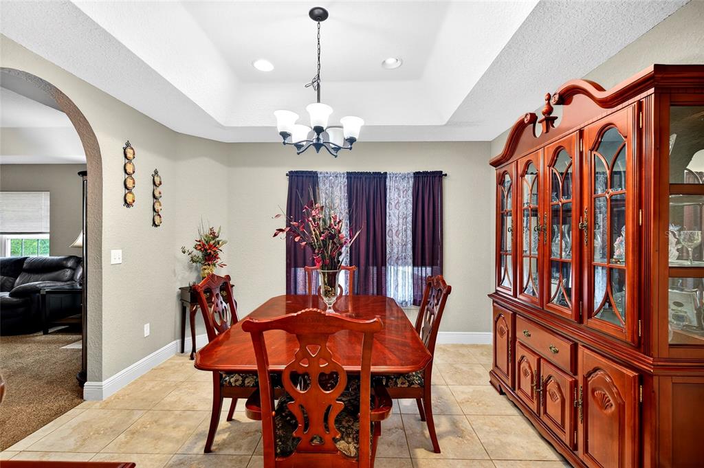 3001 Southwest 173rd Street Road Ocala, FL 34473 - Photo 7 of 28 a view of a dining room with furniture and chandelier