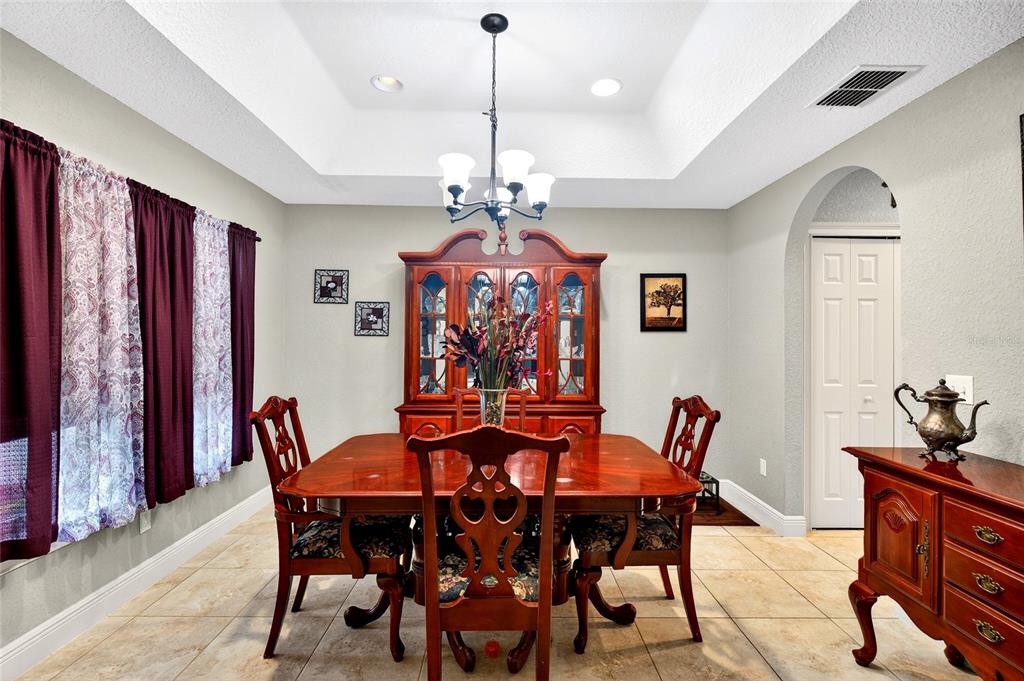 3001 Southwest 173rd Street Road Ocala, FL 34473 - Photo 8 of 28 a view of a dining room with furniture and chandelier