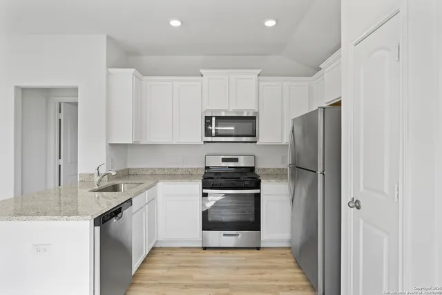 a kitchen with a refrigerator stove and microwave
