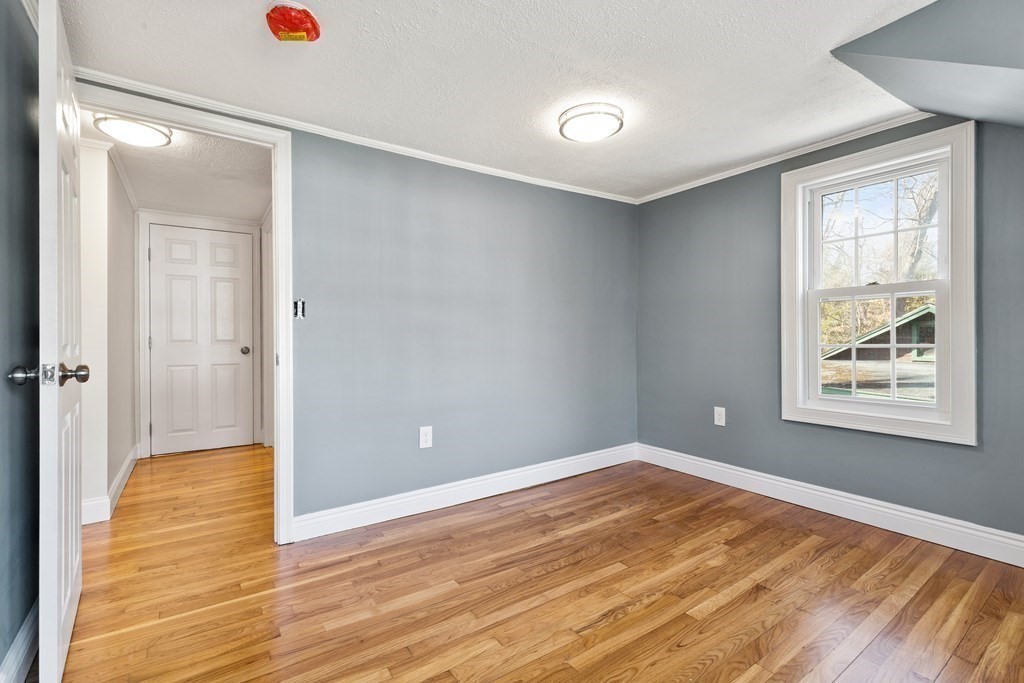 2 Pine Grove Road Westford, MA 01886 - Photo 16 of 27 an empty room with wooden floor and windows