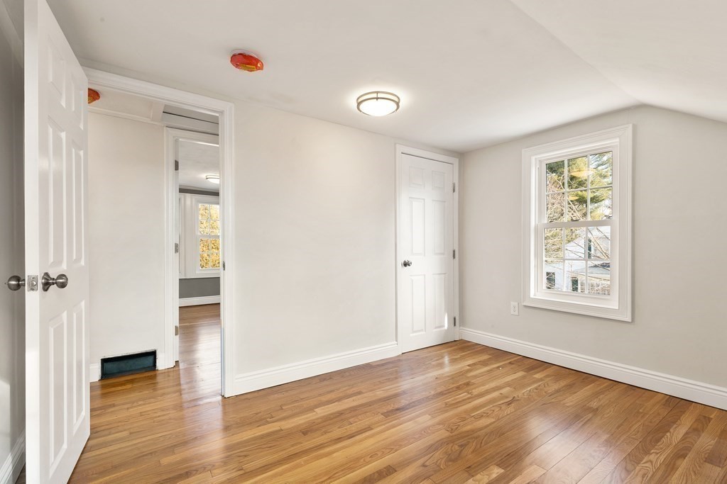 2 Pine Grove Road Westford, MA 01886 - Photo 18 of 27 an empty room with wooden floor and windows