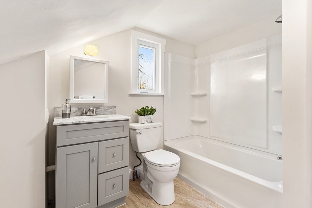 2 Pine Grove Road Westford, MA 01886 - Photo 22 of 27 a bathroom with a granite countertop toilet a sink and a bathtub
