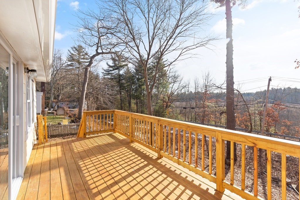 2 Pine Grove Road Westford, MA 01886 - Photo 23 of 27 a view of balcony with couch and wooden fence