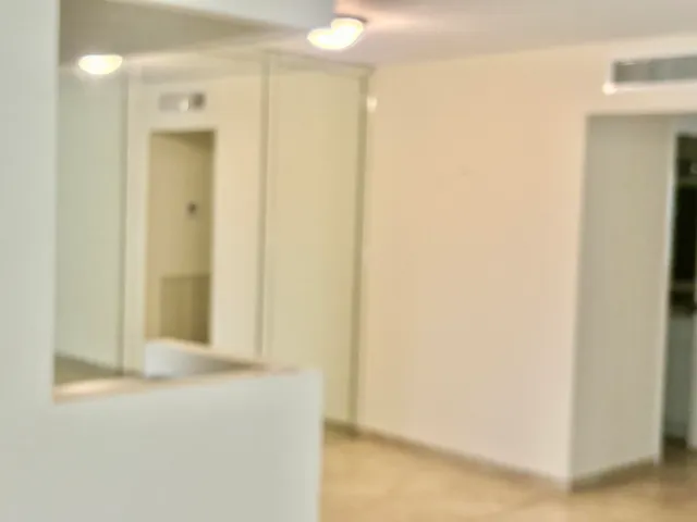 a kitchen with stainless steel appliances a stove a microwave and white cabinets