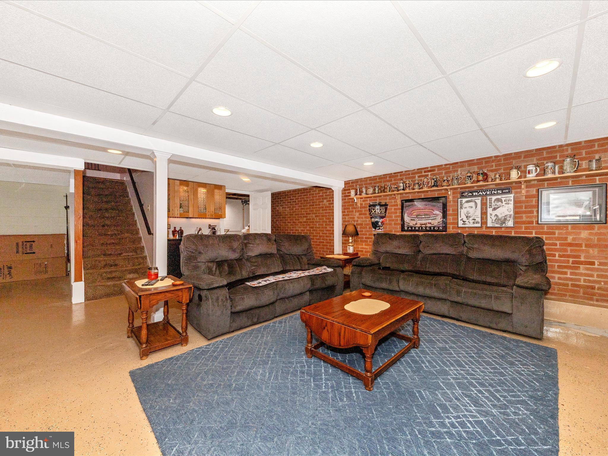 15809 Mt Everest Lane Silver Spring, MD 20906 - Photo 32 of 52 a living room with furniture a flat screen tv and kitchen view