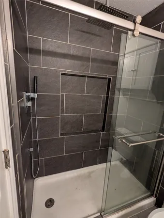 a bathroom with a shower and a sink